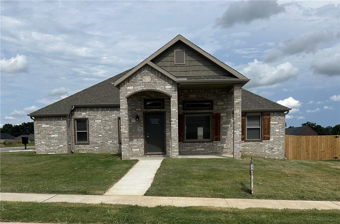 Stunning new construction—this single-story home features 3 bedrooms, 2 bathrooms, and a spacious 3-car garage. The kitchen is equipped with stainless steel appliances, a gas range, microwave vent hood, pantry, and granite countertops. A large fireplace flanked with built-in bookshelves serves as a striking centerpiece in the living room. Elegant details include wood-cased windows with 2-inch blinds throughout. Enjoy great curb appeal with a large front porch, fully sodded oversized yard, and a privacy fence. The covered back porch and fully installed gutters add both comfort and functionality. A keyless garage door pad offers convenient access. The primary suite boasts an oversized tiled shower and a walk-in closet that connects directly to the laundry room, located near the garage for added convenience. Durable brick exterior construction ensures longevity and low maintenance.