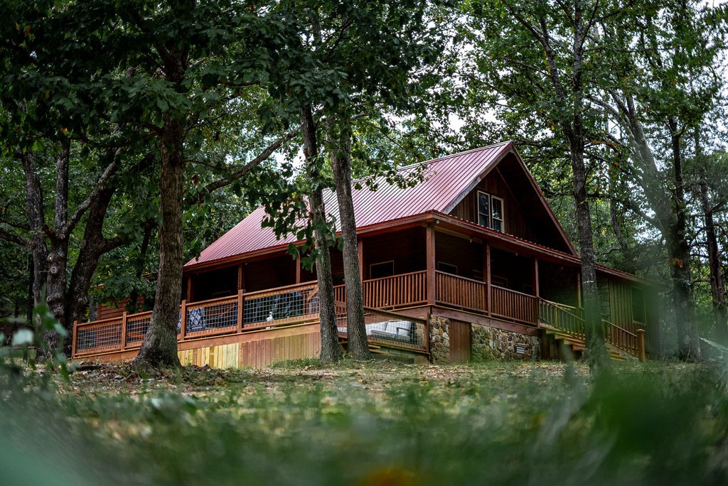 This stunning, completely renovated log cabin sits nestled on the picturesque shores of Beaver Lake! Not only does it offer a tranquil escape, but it also features a private, one-slip boat dock, making it an exceptional destination for water enthusiasts and boating aficionados.
The interior features two bedrooms, three full bathrooms, and an additional bunk room. The open-concept living area is perfect for gathering with loved ones, while the fully equipped kitchen allows you to prepare delicious meals with ease.
Step outside onto the spacious deck or enjoy making s'mores around the outdoor fire pit. Whatever your preference, this cozy log cabin sits on 5 wooded acres and offers plenty of room for outdoor activities.
An apartment is currently being finished out above the detached garage, perfect for guests or extended family. Additionally, this property caters to RV enthusiasts with a dedicated RV space complete with hookups. Come and experience the epitome of lakeside living at its finest!