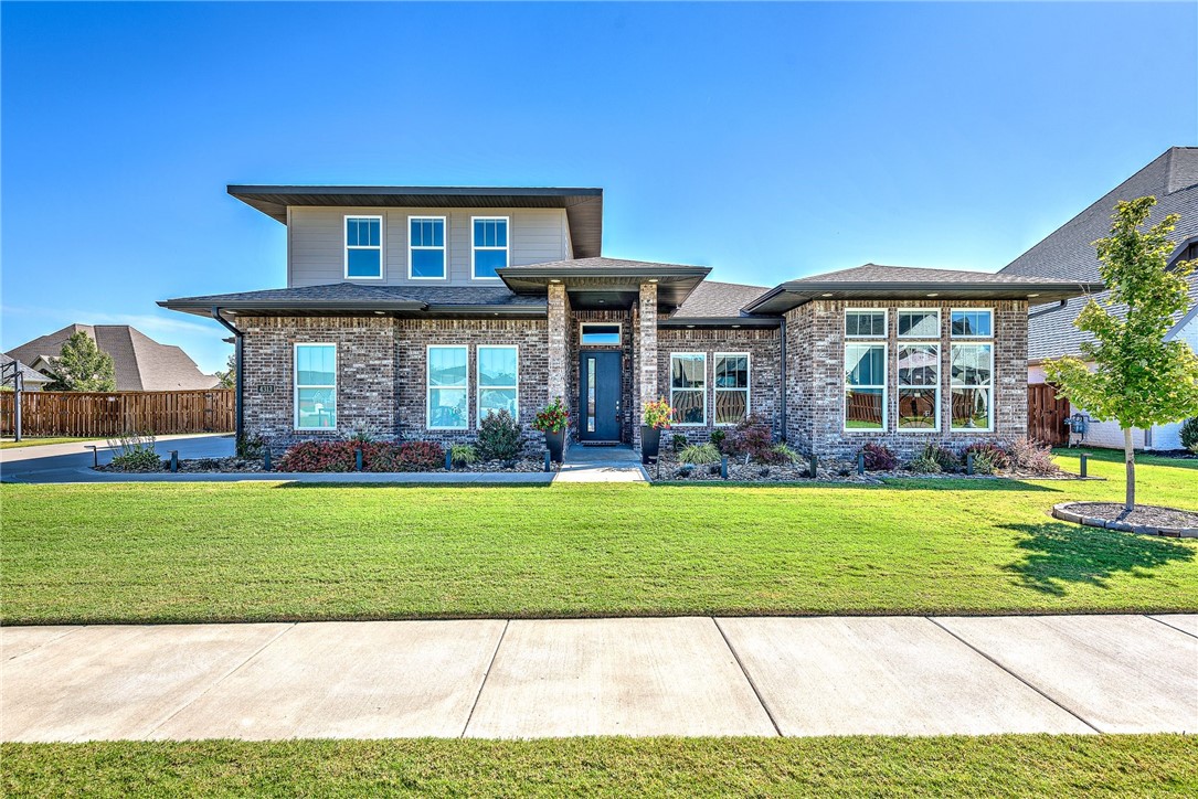 INCREDIBLE immaculate ONE-owner modern home with gorgeous exterior in sought after gated community of Scissortail. This home with an oversized lot, 3 car garage, 4 large bedrooms ALL DOWNSTAIRS, 4 full bathrooms and an open floor plan. 4th bedroom is also perfect for a study! Kitchen is open to the living room with a wall of windows producing lots of natural light. Custom motorized shades throughout, House vacuum, and Nest thermostats add to the modern amenities. Large island with veggie sink, gas cook top, tons of counter space, and walk in pantry. Large master bath with standalone soaking tub, walk-in tile shower and huge closet. Separate bonus room upstairs with full bath and wet bar. Covered patio is perfect for entertaining and relaxing! Conveniently located within walking distance of the Bentonville Schools, easy access to nearby shops, restaurants, and entertainment. Experience the wonderful neighborhood and beautiful design of this home,while being in close proximity to all Northwest Arkansas has to offer!