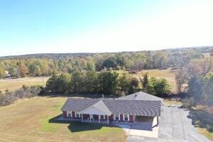 Schedule to see this home that could be used for your residential or commercial needs on 1.5+/- acres. 5 BEDROOMS, 2 kitchens, living room and game room, ADDITIONAL heated and cooled storage/bonus room, tons of storage options all on Hwy 7 frontage.