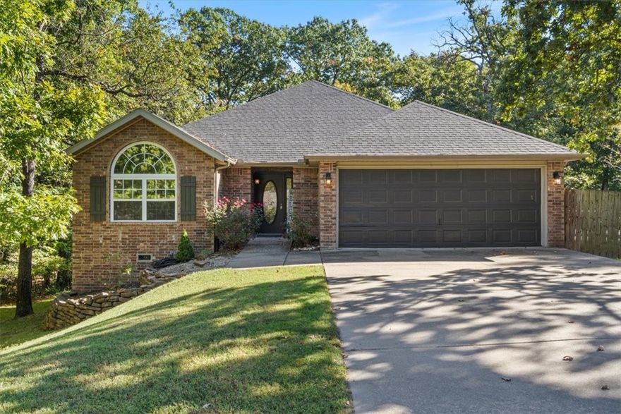 Beautifully situated on two wooded lots at the end of a quiet cul-de-sac, this 4-bedroom, 3-bath home offers 2,774 sq ft of inviting space and privacy just down the road from Back 40 Trail access. The main level features an open living room with fireplace, a spacious kitchen with stainless appliances, bar seating, and dining area, plus a flexible office with deck access. The split-bedroom layout includes a spacious primary suite with dual closets, whirlpool tub, and separate shower, along with a second bedroom and full guest bath. The walk-out basement provides an additional full kitchen, large secondary living area, two bedrooms, and a full bath ideal for guests, extended family, or a home studio. Outdoor spaces include a fire pit and seating area surrounded by trees, offering a peaceful setting for entertaining or relaxing. On sewer, double lot, and ready to enjoy!