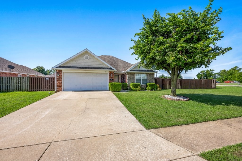 CUTE, CUTE, CUTE!! Beautifully maintained home on a spacious .27-acre corner lot with full privacy fence! Inside, the updated kitchen showcases quartz countertops, a modern sink and faucet, and stylish finishes. The living room features a cozy gas log fireplace, while engineered hardwood flooring flows throughout the home for a warm and timeless feel. Offering both comfort and convenience, this well cared for property is just minutes from downtown Rogers, local schools, parks, and I 49. Move in ready and perfectly located!