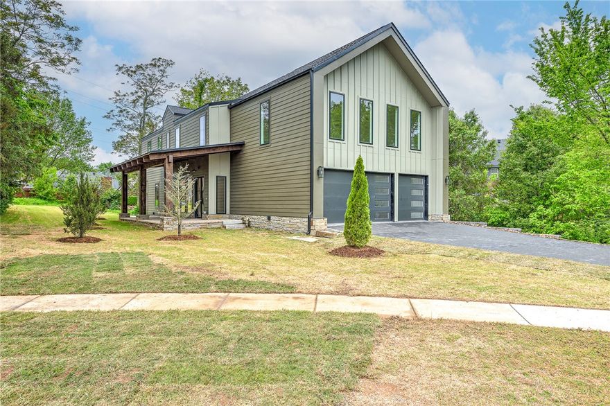 Get ready to be mesmerized by this stunning new construction contemporary gem in Fayetteville! With its inviting porch, adorned with rough cedar rafters, the grandeur of this home becomes evident. A steel frame glass front door beckons you into the spacious living, dining, and kitchen areas. On the main level you'll find the primary bedroom and ensuite with double vanities, a soaking tub, and walk-in shower. You'll also find a separate bedroom. Chesterton white oak hardwood floors grace the main areas, complemented by large format porcelain tile floors in baths, mud, and laundry areas. Ascend the floating white oak stair treads to uncover a versatile office as well as two large bedrooms. You'll also be amazed by the large game/media room with views out of the large cathedral sized windows. Additional highlights include special wall accents throughout the home, large yard and 3-car garage. With convenient access to schools, shopping, and parks, it's an opportunity you won't want to miss!