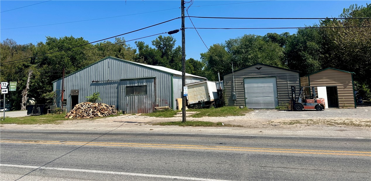 Endless opportunities on this high traffic corner lot offering multiple commercial buildings of all sizes. The property is located at the junction of two major State highways leading into the fast growing area of NW Arkansas. Building sizes are 12x26, 26x40, 36x68 currently used for a wood working shop and a 12x10 that is currently used as an office. Numerous options for this property. Lets take a look!