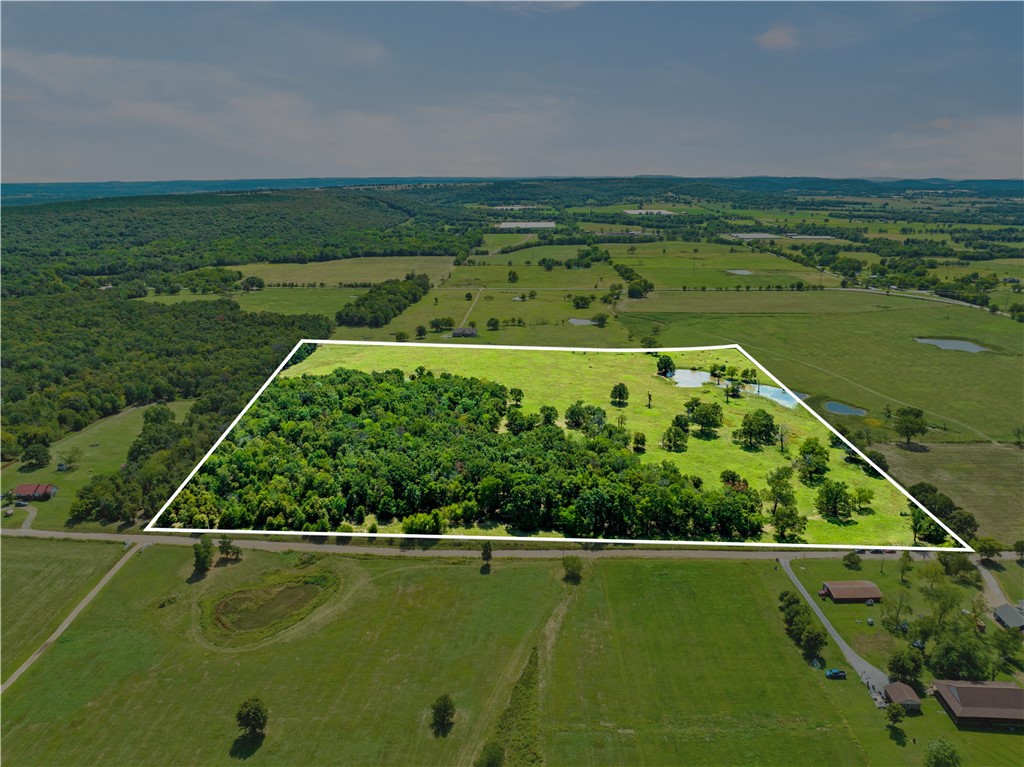 39.77 almost perfectly square acres offering endless possibilities. Located in Siloam Springs off of the newly paved Hwy 16, property is double fenced entirely along the exterior perimeters. New electrical has recently been ran to the property but will need water/sewer installation. Seller has a recent PERC test they are willing to share with any potential buyers. New survey done October of 2023, see supplements.