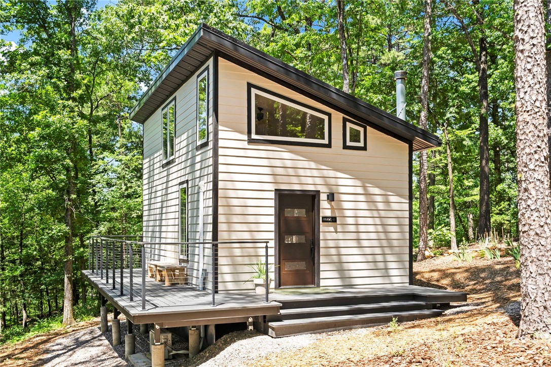 This beautiful property is nestled between Eureka Springs downtown (9 mi) and Hogscald (4 mi) on Beaver Lake! With 8.14 acres just a mile off of Highway 23, this private retreat has a newly built Studio (624 sq ft), a second ready to build site w $100K in completed infrastructure - underground electric, 3ā4BR septic, and 60 GPM glacier-fed well 1207 ft deep (Roubidoux Aquifer-the purest water). Fire-resistant construction with Hardy siding, metal roof, and rock wool insulation. No chemicals used on the propertyāonly cedar oil, diatomaceous earth, and Pyrethrin. Sustainable organic food forest with figs, strawberries, heirloom bulbs, and shiitake mushrooms. Features Van Gogh-inspired garden, Indian Trail Marker Tree, and Earthling Trail. Ideal for homestead, STR, or build-site. Looking to build but don't want to pay for the well, septic or electrical? Or looking for a short term rental? This property is for you! Schedule your private in person tour today!