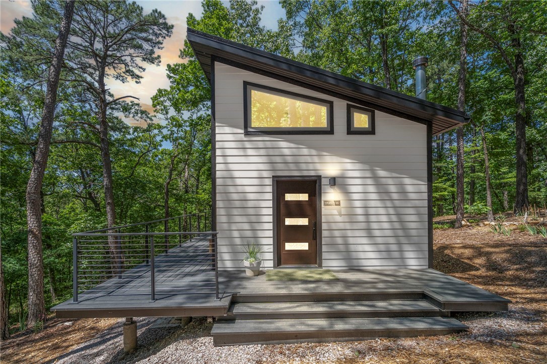Welcome to this extraordinary 8.14-acre retreat and Studio near Beaver Lake with $100K in ready to build infrastructure! No other lot has this complete list. Includes 2024-built Studio 55, second build-ready site, underground electric, 3–4BR septic, and 60 GPM glacier-fed well 1207 ft deep. Fire-resistant construction with Hardy siding, metal roof, and rock wool insulation. No chemicals—only cedar oil, diatomaceous earth, and Pyrethrin. Sustainable food forest with figs, strawberries, heirloom bulbs, and shiitake mushrooms. Features Van Gogh-inspired garden, Indian Trail Marker Tree, and Earthling Trail. Ideal for homestead, STR, or build-site. Just 8 mi to Eureka Springs; 12 mi to Clifty Drop In or Hogscald, at Beaver Lake. Looking to build but don't want to pay for the well, septic or electrical? How about a short term rental? This property is for you! Schedule your private walking tour today!