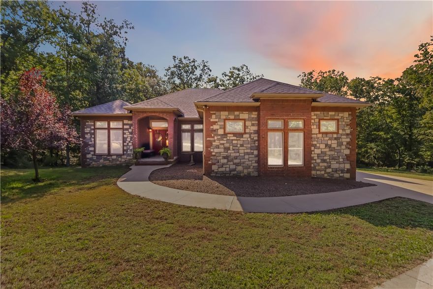 Discover the perfect blend of privacy, space, and convenience with this custom-built home tucked away on almost 8 acres—just 15 minutes from Downtown Bentonville and near the area’s bike trails. This one-level home offers 4 bedrooms, 2 full baths, and a home office for work or study. A bonus room and safe room in the basement (with private exterior access) bonus room sq. ft. included in heated/cooled space—ideal for hobbies, storage, or a retreat. Inside, you’ll find custom wood cabinets and solid prefinished wood floors ready for refinishing. Step outside to the covered deck and enjoy views of the wooded property. The land is perfect for a hobby farm, with fruit trees, grape vines, gardens, and flowers at the front. A 30x40 barn provides ample storage and workspace. A creek runs through the property—once home to a private shooting range. Neighborhood covenants allow one home per 5 acres, preserving the country setting while keeping you close to Bentonville.