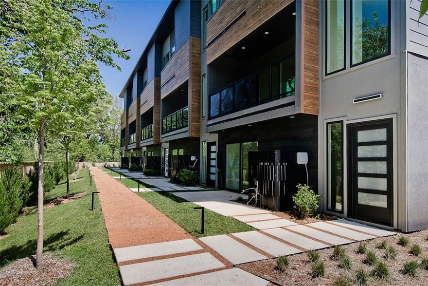 WELCOME TO DISTRICT 9/A! 30 year fixed rate financing available! Modern living located across the street from Airship Coffee! Situated near the Crystal Bridges trail and the downtown square, this brand-new back corner unit offers both convenience and contemporary design. The property includes an attached 2-car garage and a community bike wash station, perfect for outdoor enthusiasts. Additional neighborhood amenities feature an outdoor grill and a fire pit, ideal for social gatherings. The contemporary kitchen is a highlight, featuring European cabinetry, exquisite quartz countertops, and a waterfall island. With modern fixtures and custom finishes throughout, this condo exemplifies quality. Enjoy the elegance of glass balconies and the comfort of 3 luxurious bedrooms. The condo also includes 3.5 baths, designed with style and functionality in mind. Experience the ultimate luxury lifestyle with this exceptional property. Additional units are available.