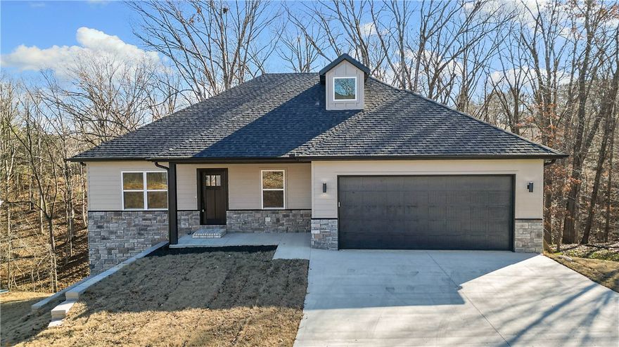 Beautiful New Custom Home in Bella Vista! Situated on a .33-acre sewered lot, this stunning board-and-stone home offers 4 bedrooms plus an office. The open concept living, kitchen, and dining areas flow seamlessly onto one of two decks, offering fantastic views and a relaxing outdoor space. The walk-out basement boast a large family room with access to the second deck and backyard, perfect for entertaining or relaxing. Enjoy custom cabinetry and a quiet side-mount garage door opener. Just 1 minute to Metfield Clubhouse for golf and fitness, with trails, swimming, tennis, lakes, playgrounds, and skills park nearby. Only 8 minutes to Bentonville city limits!