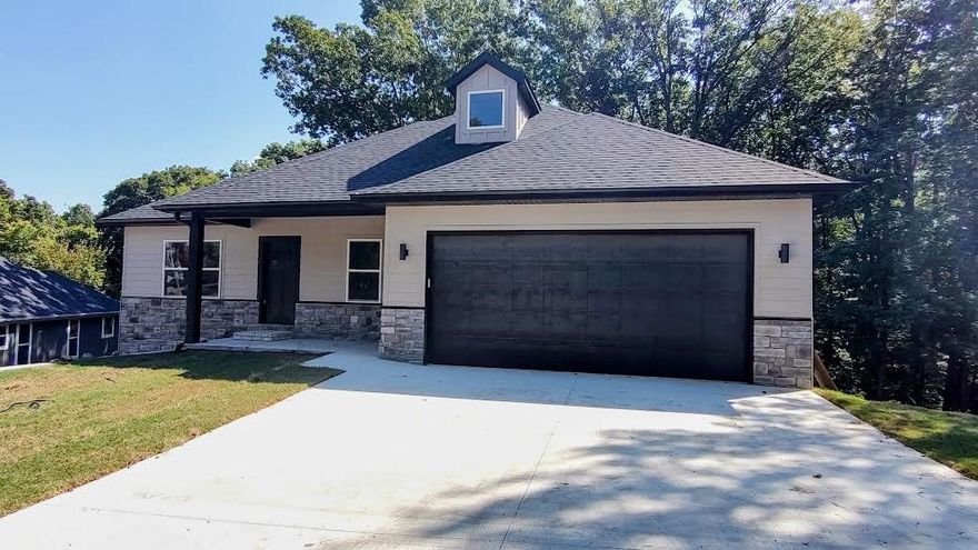 Beautiful New Custom Home in Bella Vista! Situated on a .33-acre sewered lot, this board-and-stone home offers 4 bedrooms plus an office. The open concept living, kitchen, and dining areas lead to one of two decks with fantastic views. The walk-out basement features a large family room with access to the second deck and backyard. Enjoy custom cabinetry and a quiet side-mount garage door opener. Just 1 minute to Metfield Clubhouse for golf and fitness, with trails, swimming, tennis, lakes, playgrounds, and skills park nearby. Only 8 minutes to Bentonville city limits!