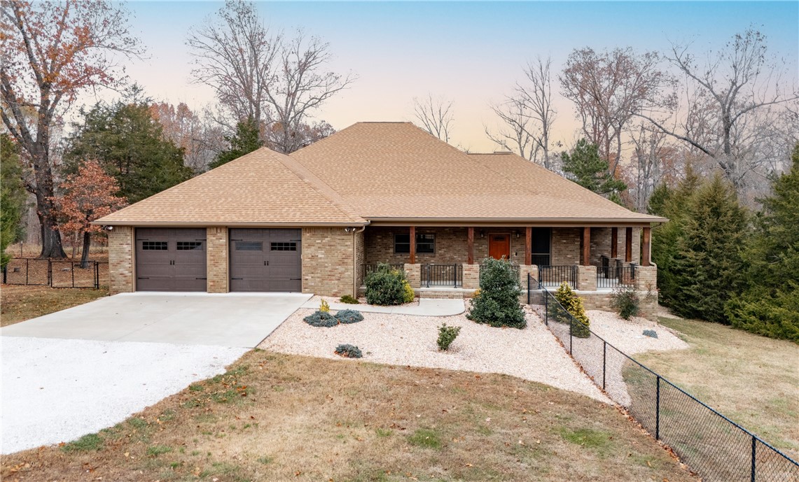 The impossible find! Tucked right between Beaver Lake and Downtown Rogers, this immaculate custom-built 2,800 sf home is packed with high-end finishes, appliances and thoughtful details. It features a whole-home generator, highly energy efficient tankless water heater, and a dual-fuel Lennox HVAC system for year round comfort. Custom cabinets throughout with an office, dedicated laundry and a separate mud room. The property also includes a 24x36 detached 3-car garage/shop, fully finished and ready for your projects or extra storage. With most of the acreage fenced, it’s perfect for most any animals you could want. A truly unique property offering both luxury and functionality in a very private setting.