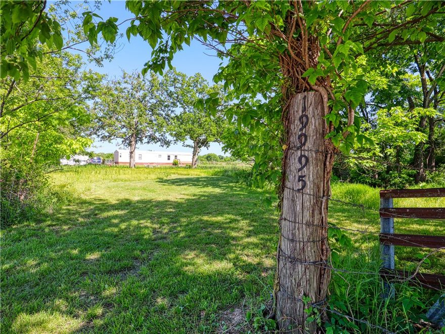 Looking for an affordable full-time residence or a comfortable place to live while you build your dream home on the same land? This property checks all the boxes. Nestled on 1.65 beautiful acres, this move-in-ready 2-bed 2-bath home offers the perfect blend of comfort, space, and opportunity. 20x10 storage shed and fenced back yard. With mostly flat terrain and a wonderful mix of mature trees and open land, the property feels like a private retreat while staying just 10 mins from downtown Siloam Springs.
