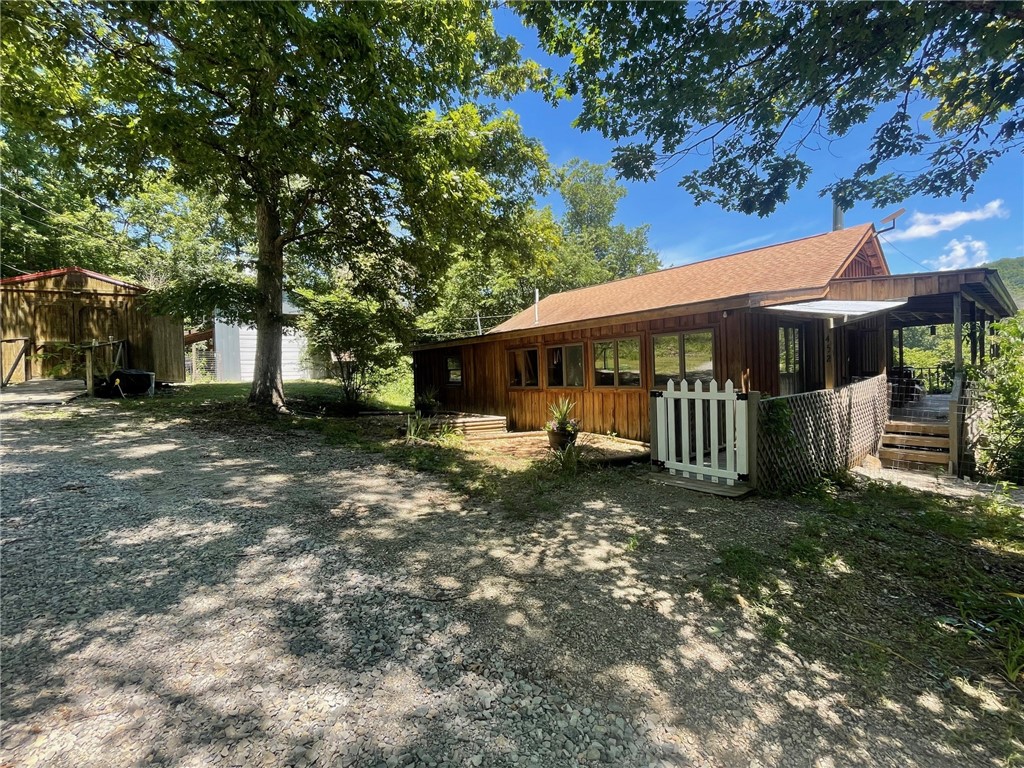 Welcome home to your Ozark oasis on the beautiful Georgeās Creek! This property boasts 10.56 unrestricted acres m/l, a mix of pasture and wooded areas. The home overlooks Georgeās Creek with beautiful views of abundant wildlife. This two-bedroom one bath home has 1588 sf, custom tongue and groove wood walls and beautiful pine floors. There is a 20 x 30 shop building with concrete floor, 3 storage sheds, and alsoa she-shed ready for your imagination!