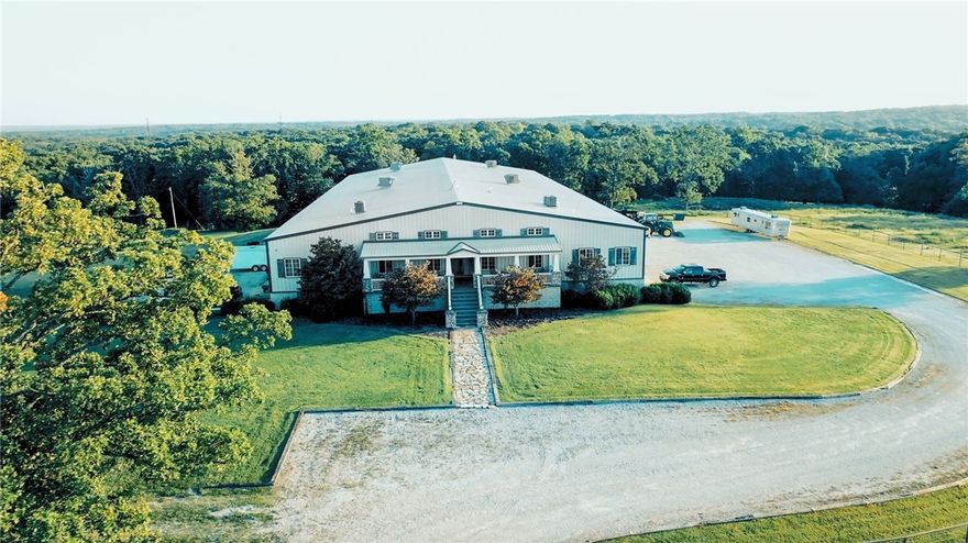 Discover Twelve Stones Ranch — a 145-acre destination in Northwest Arkansas offering a rare combination of beauty, function, and potential. Behind a gated entrance, a half-mile drive winds past rolling pasture, custom pipe fencing, and double ponds, leading to the heart of the property.  Here, a 2,500 square foot barndominion-style homestead provides four bedrooms, four bathrooms, a full kitchen, dining room, and living room with fireplace. A wide porch opens to sweeping views, creating the perfect place to gather and unwind. Connected to the home, a 20,000 square foot shop delivers unmatched capability. Ten roll-up bay doors, advanced climate control, office space, tornado shelter, backup power, and Starlink internet make this space ideal for ranching, hosting, storage, or business operations. Additional improvements include a three-bedroom ranch manager’s home with full utilities and tornado shelter, as well as a livestock watering system and thoughtfully designed infrastructure throughout.