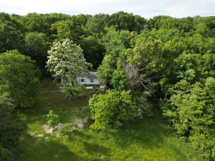 Discover the potential of this beautiful 6-acre property, perfectly tucked just off the highway for easy access while maintaining a peaceful, private feel. Mostly wooded with mature trees, this land offers a serene natural setting and multiple potential building sites ideal for your dream home or investment opportunity. Included on the property are an old farmhouse and barns—full of rustic charm and possibilities for restoration or repurposing. Whether you're looking for a place to build, explore, or invest, this property brings together location, character, and versatility in one scenic package.