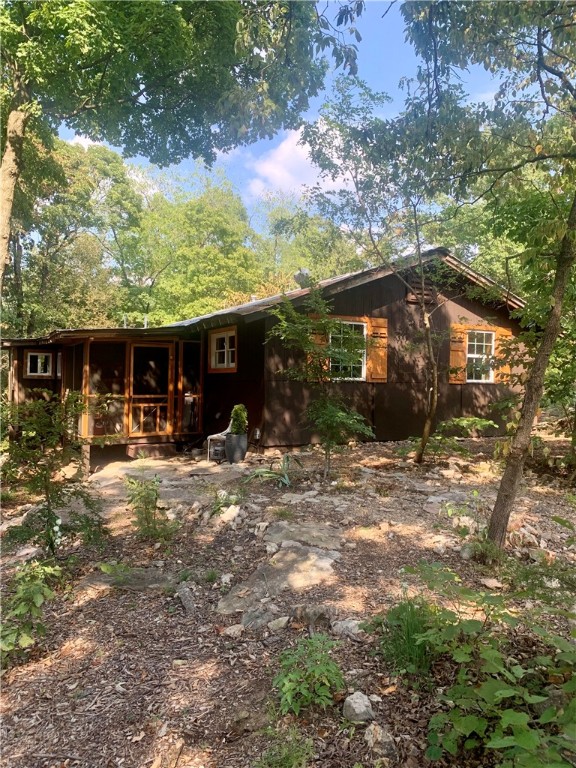 Welcome to your very own woodland retreat! Nestled on 9.5 serene acres, this delightful 1970s cabin offers the perfect blend of rustic charm and modern convenience. Located just a short drive from the vibrant town of Eureka Springs, the scenic Holiday Island,and the White and Kings Rivers, this property is ideal for those seeking a peaceful escape with easy access to local amenities. The wood burning stove offers a cozy feel for those winter months. Property can be subdivided into not less than 2 acre parcels as allowed by the covenants.