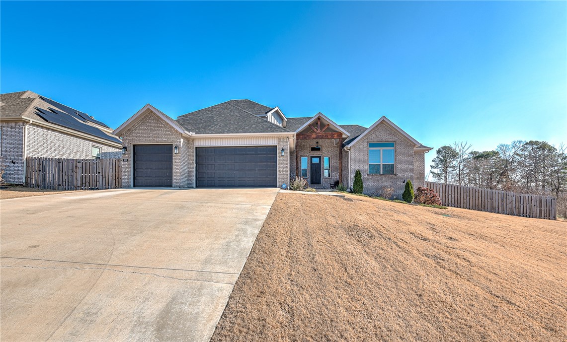 This 2022-built home features 4 bedrooms and 3 bathrooms, with a gunite pool and Frog system installed in 2023 in Elm Springs. The property boasts custom built-ins, crown molding, and two gas fireplaces—one in the living room and another on the covered back patio. Situated on a 1/2-acre lot, the home includes a bonus room, an eat-in kitchen, and a spacious backyard perfect for entertaining. Ideally located between Cave Springs and Elm Springs for easy access to both areas and easy commute to anywhere in NW Arkansas. Let's make this your new home! TV's & Bose speakers do not convey, but the mounting brackets will. Stainless steel fridge in kitchen and wall mounted workout rack in the garage do not convey either.