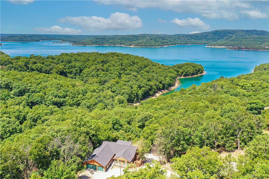 Enjoy this 11.89 acre Lake Front home with beautiful view of Beaver Lake without restrictions. Home is on Eagle Cove with deep blue water which gives you a Caribbean feel. Corp line is in the middle of the water at one point. Large majestic bluffs, wet weather creek that runs through the property. Large Hardwoods that tower. This property has so much potential for a business or private retreat. Just a few hundred feet from the entrance of Starkey Park Marina. This adjoins 15 acres of Government property.
No Seller Property Disclosure. Property being sold as is.