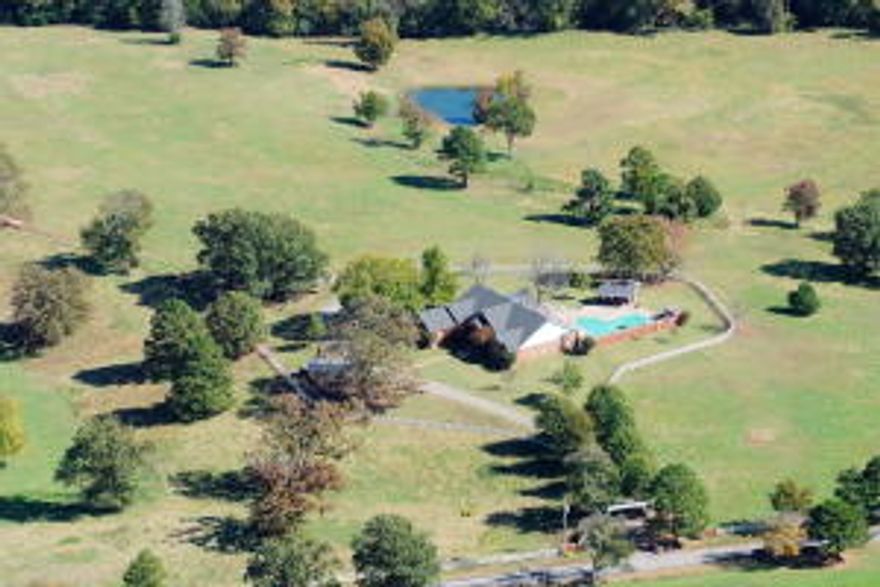 This is a rare opportunity to have one of the most picturesque settings with Mt Nebo as the backdrop. This stately brick home comes with 55+ acres. The land is fenced and cross fenced with 2 ponds. The home offers 4 bedrooms one currently office and an extra space upstairs. 4 total bathrooms with 3 bedrooms having their own bathroom. The large master bedroom overlooks the lush pasture and one of the 2 ponds and has 1 door to the outside and 1 door onto the sunroom. The master bathroom offers a jacuzzi tub and separate shower and walk in closet. Brand new heat and air unit, 3845 sq ft with large living and dining area, very spacious kitchen, formal dining area, sunroom that opens out onto pool area,(pool needs liner, $10,000 credit for new pool liner and to fill pool, or to have filled in)