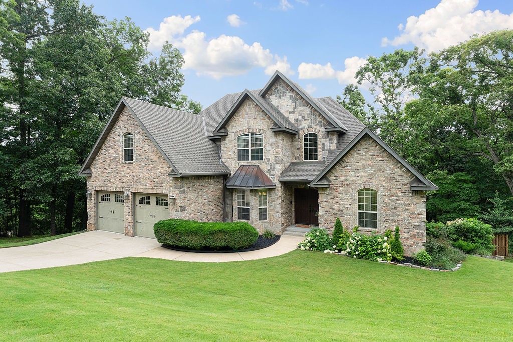 Peaceful Beaver Lake area home, only 5 min to the lake, 10 min to downtown rogers. This custom home has been meticulously cared for. 4 bd, 3.5 baths on 3 levels with 3 separate living areas! Roof replaced 2021, both HVAC’s 2023. Open kitchen living concept with large island, cherry cabinets, gas cooktop and double ovens, slate floors. 2 spacious decks overlook a lush valley. Lower-level game room has kitchenette, with kegerator. Furniture and Additional .70 lot next door negotiable.
