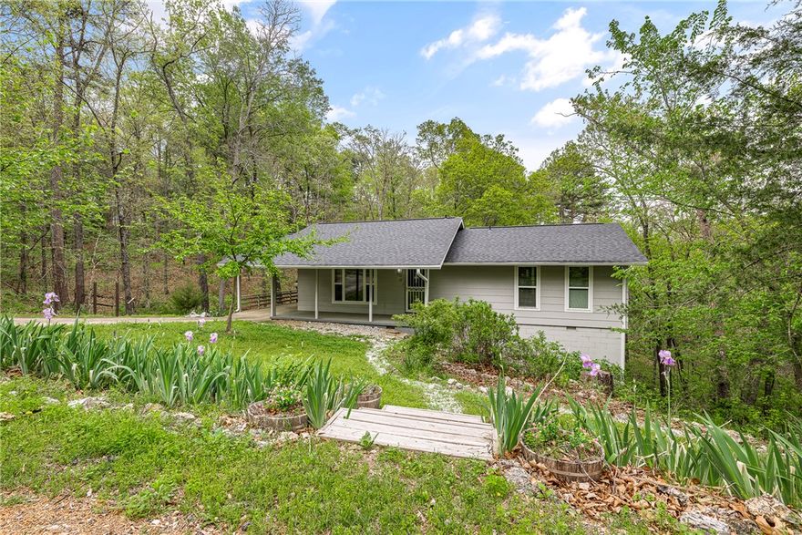 Tucked into a quiet, wooded setting with no rear neighbors, this home offers a rare blend of privacy, nature, and flexibility, ideal as a full-time residence, weekend getaway, or proven short-term rental.

Inside, you’ll find updated flooring, fresh paint, and a remodeled kitchen and bathrooms that create a clean, comfortable, move-in ready feel. The two-bedroom, two-bath layout works well for everyday living or hosting guests.

The outdoor setting truly stands out. A welcoming covered front porch sets the tone, while the backyard opens to wooded views with direct trail access leading to Lake Ann. Enjoy peaceful mornings or evenings surrounded by nature and wildlife.

Recent updates include a new roof and gutters in 2023, added insulation, and a newer septic system. Offered fully furnished, this turnkey property also features established Airbnb history, making it a strong opportunity for personal use or income from day one.