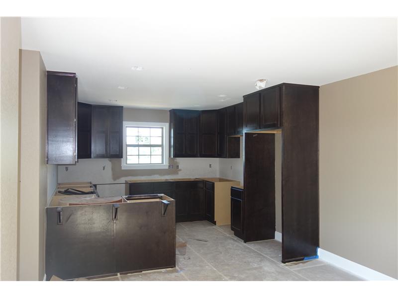 Brand New quality built home by P.M. Construction. This home has EVERYTHING! 4 Bedrooms 2 Bathrooms, Granite counter tops in kitchen and bathrooms, Real wood cabinets throughout, large walk in closet in master with built in shelves,Real wood floors in living room and hallway, ceramic tile in wet areas, carpet in bedrooms, Engery efficient windows and stainless steel appliances, SAFE ROOM in garage!!! Additional lot to the right of the property is negotionable.