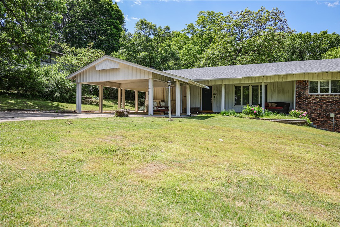 Welcome to 1741 N Greenvalley Ave, a charming 3-bedroom, 3-bathroom home nestled in the heart of Fayetteville's Green Valley Subdivision. This spacious home is a perfect blend of comfort and potential. The main level features 2 large living areas and an eat-in kitchen area. The finished basement provides additional living space, ideal for a second living area, home office, or bonus room, complete with a full bath and wonderful sunroom. Enjoy the outdoors on the covered patio, perfect for relaxing or entertaining. The home is situated on 2 lots with mature trees, offering a peaceful and private setting. Conveniently located near the VA Hospital, schools, and mountain biking trails, with easy access to the University of Arkansas campus. Recent updates include new interior paint, new HVAC in 2021, and a new roof in 2020. This home is ready for your personal touch and offers endless possibilities. Don't miss the opportunity to make this your next home!
