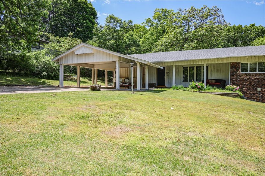 Welcome to 1741 N Greenvalley Ave, a charming 3-bedroom, 3-bathroom home nestled in the heart of Fayetteville's Green Valley Subdivision. This spacious home is a perfect blend of comfort and potential. The main level features 2 large living areas and an eat-in kitchen area. The finished basement provides additional living space, ideal for a second living area, home office, or bonus room, complete with a full bath and wonderful sunroom. Enjoy the outdoors on the covered patio, perfect for relaxing or entertaining. The home is situated on 2 lots with mature trees, offering a peaceful and private setting. Conveniently located near the VA Hospital, schools, and mountain biking trails, with easy access to the University of Arkansas campus. Recent updates include new interior paint, new HVAC in 2021, and a new roof in 2020. This home is ready for your personal touch and offers endless possibilities. Don't miss the opportunity to make this your next home!