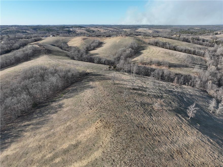 190 +/- acres of Northwest Arkansas countryside offering a blend of functionality. This family-owned cattle ranch has been operated by the same family since 1994. It features open pastureland ideal for cattle, horses, or hay production. Improvements include corrals, cross fencing for rotational grazing, pole barns, and self-filling water tanks designed for efficiency, chicken coops, office building currently used as a tax preparation office. Three ponds provide excellent water sources and enhance the scenic appeal. A comfortable 1,500 sq ft home overlooks the land. Whether you’re seeking a working ranch, wanting to expand your operation, or just have a private rural self sustaining homestead, this acreage delivers versatility and value. Located just 30 minutes from the growing cities of Northwest Arkansas, offers easy access to Fayetteville, Springdale, Rogers, and Bentonville, giving you peace and privacy of rural living.