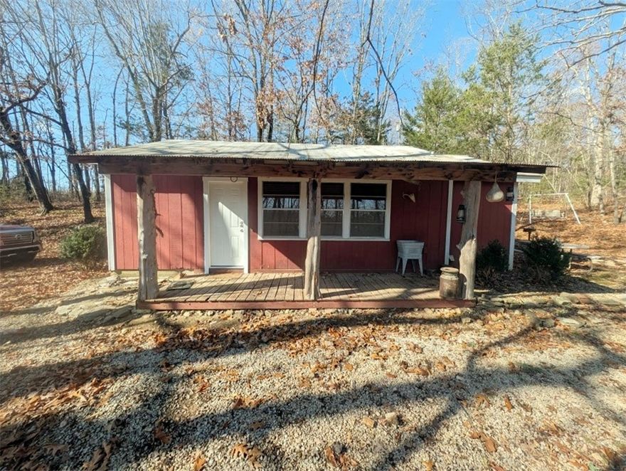 Looking for privacy & seclusion in a convenient location not too far out?  Here's a small home or hunting cabin tucked away on 5.22 secluded acres offering the perfect blend of privacy, comfort, and convenience. Just minutes from the Buffalo National River, it features an open floor plan, a  metal roof, and easy access via approximately one mile of well-maintained dirt road.  Surrounded by the natural beauty of the Ozark Mountains, this property is ideal for a plethora of nearby outdoor activities such as hiking, hunting, floating, fishing, rock climbing, horseback riding, biking, ATV riding, photography or simply enjoying peace and quiet in the woods.  Property can be sold fully furnished or it can be emptied prior to closing.  All #s are approx, square footage per Assessor.  Buyer to verify existence of all utilities.
