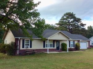 Welcome Home to this 3 bedroom,2 full bath beauty with split floor plan. Vaulted ceiling and open floor plan with kitchen overlooking the living and dinning areas. Jacuzzi with separate shower in master bath with double vanities and a walk in closet. Lamlock wood look floors, tile in the wet areas. Sits on 1 full acre of land with a small creek at the back. A 12 X 23 Covered screened porch. Outbuilding in the back yard. Also a 24 X 24 attached Garage. Call for your showing appointment today!
