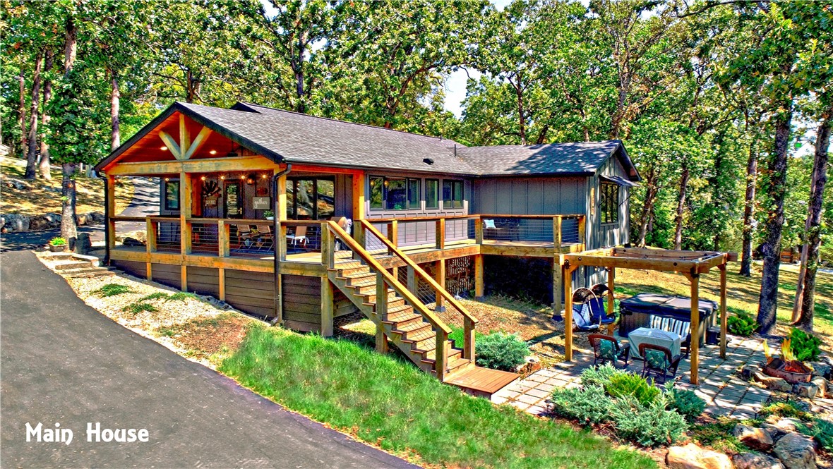 TWO 12x30 SLIPS IN SEMI-PRIVATE BOAT DOCK only a 2 minute walk from house! You will not believe your eyes when you see this one. Main House 1452sf, Guest House 520sf, Bunk House 1200sf all on 1.37 acres. Sleeps 15 comfortably with room to spread out. Main house remodeled down to the studs 2021. It has 2 bedrooms, 2 baths, laundry room, kitchen and living room with fire place. Ten foot quartz kitchen island with beautiful seasonal view of the lake. Covered deck off of living room. Patio with hot tub. Guest house has spectacular year round lake view, kitchenette, bath with shower. Storage/garage space underneath. Bunk house has 3 bedrooms, bath and a flex space being used as a bedroom. Second story deck and storage/ garage space. Some furnishings convey. See attachment for more info.
