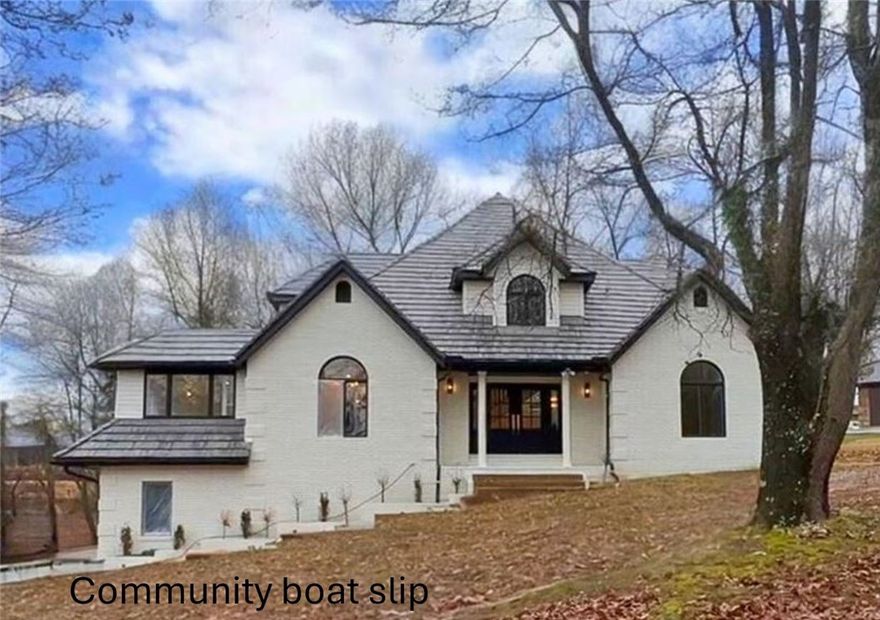 Welcome home to this beautiful Rogers Lake home with a community slip on Beaver Lake AND located close to town in Rogers! This home has been completely remodeled with every room updated. Property has a seasonal view and large driveway for extra parking. 3 levels of lake living offer 3 bedrooms and 2 additional rooms in the basement that have closets for extra rooms. Property has 2 living rooms that open to the kitchen for great entertaining. Large multi-level TREX deck with spacious back yard. Main floor primary ensuite with large walk-in tiled shower and large closet. Custom Kitchen with new countertops, appliances and pantry by the main floor laundry room. Kitchen offers central location for both living areas. 3 Car garage with extra storage. New DaVinci composite roof will last a lifetime and new white oak flooring for easy maintenance throughout main floor.  To many updates to mention!