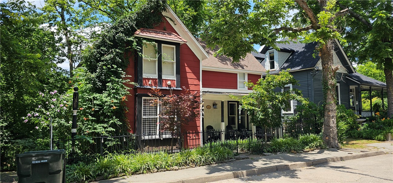 The sweet "Tea Cup Cottage" is located on the Historic Loop which also connects to walking trails and sidewalks to downtown Eureka Springs for shopping and entertainment. The home has had many upgrades including 4 mini splits for the convenience of zoned heating and air. The kitchen has stainless steel appliances and granite countertops, its beautiful! The kitchen opens up to a large back deck to enjoy your morning coffee and listen to the birds in a treed surrounding. The covered front porch is perfect for watching life go by. The main bedroom is on the first level and 2 bedrooms are on the upper level. The property is zoned commercial and is currently being used for a very successful Airbnb. You can see more info on "Evolve" Also crossed listed mls #1306472