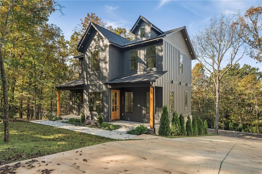 Perfectly located within a few miles of the University of Arkansas, this newly constructed home was completed on August 15th and showcases exceptional quality throughout. Featuring four bedrooms, each with its own ensuite bathroom, this property includes luxury finishes such as tinted Weatherbarr windows, granite countertops, Frigidaire Professional appliances, Fanimation ceiling fans, and Delta fixtures. Designed for efficiency and comfort, it offers a two-stage HVAC system, insulated walls and floors, and premium engineered wood flooring with carpet in the bedrooms. The walkout basement leads to an oversized two-car garage and a spacious driveway—ideal for entertaining on game days. Enjoy sunset views and wooded privacy on three sides. Additional highlights include poured stem walls, French drains, a front patio, custom exterior lighting on an automatic timer, and a one-year builder warranty.  Schedule your showing today!