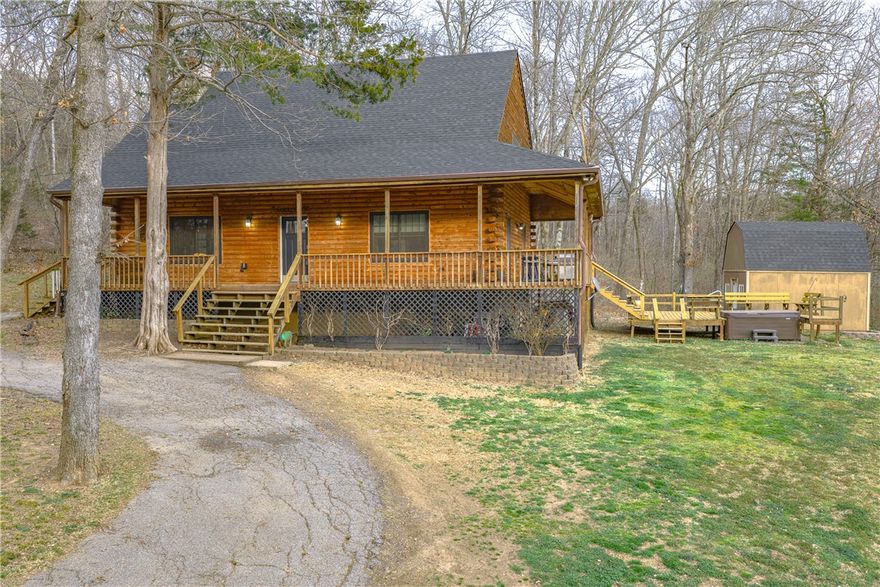 Country estate on 13.28 acres just outside the city limits but only 5 minutes to Drake Field, schools, restaurants and shopping. Custom log-sided home features a new roof on the house and storage shed. Enjoy the pastoral views from the covered wrap-around porch, hot tub, pergola or firepit. Vaulted ceilings, large loft and wood stove anchor the open floorplan. Updated kitchen with granite countertops and island plus a pantry. Private primary suite features walk-in closet, large ensuite bath with jetted tub, dual vanities and separate shower. Handy mudroom with outside door. Perfect for a hobby farm and/or nature enthusiasts with a mix of pasture and woods. Live in now and build in one of many additional home sites. Abundant wildlife with pond and creek. Located off a paved road with circle drive, storage shed, pole barn and chicken coop. Updated water heater, flooring and Andersen windows.