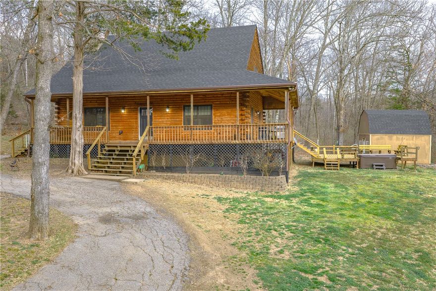 Escape to your country estate on 13.28 acres. Custom log-sided home has NEW roof on the house and storage shed, updated Andersen windows, flooring and water heater. Enjoy the pastoral views from the covered porch, pergola or firepit. Vaulted ceilings, large loft and wood stove anchor the open floorplan. Updated kitchen has granite countertops and island plus a pantry. Private primary suite features large ensuite bath with jetted tub, dual vanities and separate shower. Handy mudroom with outside door. Perfect for a hobby farm and/or nature enthusiasts with a mix of cleared pasture and woods. Plentiful wildlife with large pond and a creek. Great location only 10 mins. from downtown Fayetteville and less than 5 mins. to Drake Field, schools, restaurants and shopping. Located off a paved road with circle drive, storage shed, pole barn and chicken coop.