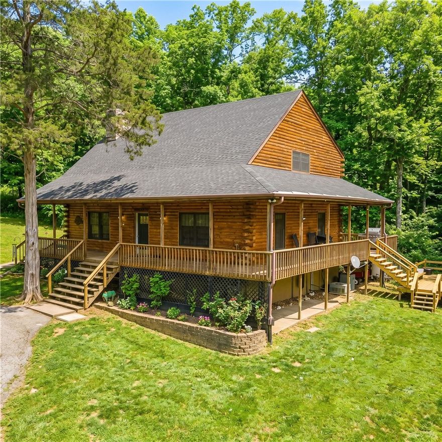 Country estate on 13.28 acres just outside the city limits but only 5 minutes to Drake Field, schools, restaurants and shopping. Custom log-sided home features a new roof on the house and storage shed. Enjoy the pastoral views from the covered wrap-around porch, hot tub, pergola or firepit. Vaulted ceilings, large loft and wood stove anchor the open floorplan. Updated kitchen with granite countertops and island plus a pantry. Private primary suite features walk-in closet, large ensuite bath with jetted tub, dual vanities and separate shower. Handy mudroom with outside door. Perfect for a hobby farm and/or nature enthusiasts with a mix of pasture and woods. Live in now and build in one of many additional home sites. Abundant wildlife with pond and creek. Located off a paved road with circle drive, storage shed, pole barn and chicken coop. Updated water heater, flooring and Andersen windows.