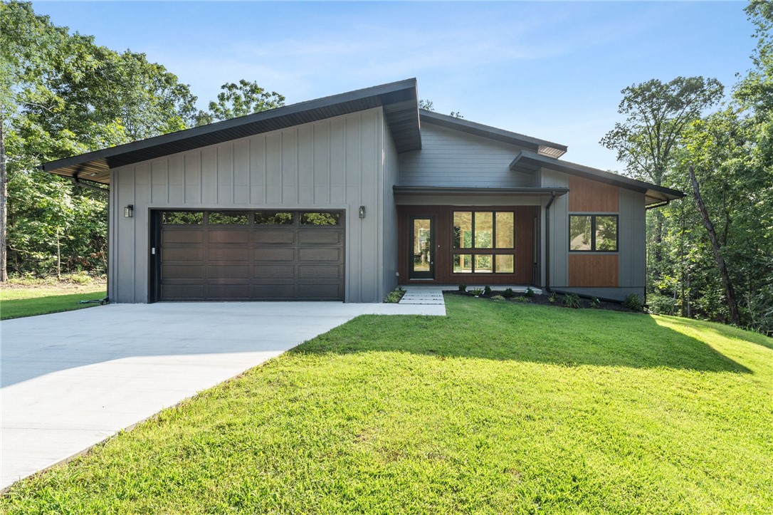 Welcome to this beautifully-crafted new construction home that offers 2 spacious bedrooms, 2 full baths, & a versatile bonus room. Located just minutes from the Branchwood Recreation Center, Interstate access, & the Highland Golf Course, this thoughtfully designed home offers the perfect balance of convenience & comfort. Step inside to a bright, open-concept living space highlighted by large windows, an electric fireplace, & high-quality hardwood flooring flowing throughout the living areas. The kitchen features a center island & floating shelves, while the covered front porch & expansive deck overlooking an oversized lot invite you to relax. The primary suite includes a custom-tiled walk-in shower, and with sound-insulated interior walls throughout you will have calm and privacy in every bedroom. Need a workspace? The garage is fully-insulated with a connection for a mini-split, primed as an all-season workshop. Loaded with too many thoughtful features to list, come see for yourself today!