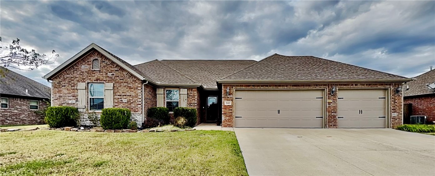 Stunning east-facing brick home with easy access to all of NWA and a 3-car garage! Enter through a welcoming foyer and find a soaring ceiling in the living room, complete with a gas fireplace. This open layout is ideal for entertaining, with a spacious kitchen, pantry, and gas range perfect for the home chef (refrigerator stays). A split-bedroom layout ensures privacy for all. The primary suite is a true retreat, featuring a large walk-in closet, dual vanities, a soaking tub, and a walk-in shower. Three additional bedrooms offer great natural light and ample space.
The fenced backyard has a covered patio and custom deck with a pergolaāperfect for outdoor relaxation. A shed provides storage for yard essentials. The 3-car garage includes a pony wall, offering flexible use for the single stall. Enjoy added security with a built-in storm shelter.
Explore the virtual tour to experience this beautiful home, then schedule your showing today!