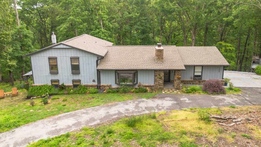 This well-maintained split-level home sits on 2.71 acres with several upgrades. In 2022; new roof, new hot water heater, updated back deck/porch area, new insulation blown into the attic, kitchen plumbing has been replaced, and the septic system has been pumped and serviced. New HVAC system installed in 2024. The living room boasts a huge stone fireplace that has recently been cleaned and serviced and also a large bay window allowing ample natural light. The lower split has been updated which also features a wood stove, a kitchenette, and a remodeled half bathroom. The eat-in kitchen and main suite both have exterior doors leading to the multi-level updated decking. This home is approximately 10 minutes from downtown Rogers, 5 mins from Beaver Lake access, and 4 mins to Hobbs State Park!