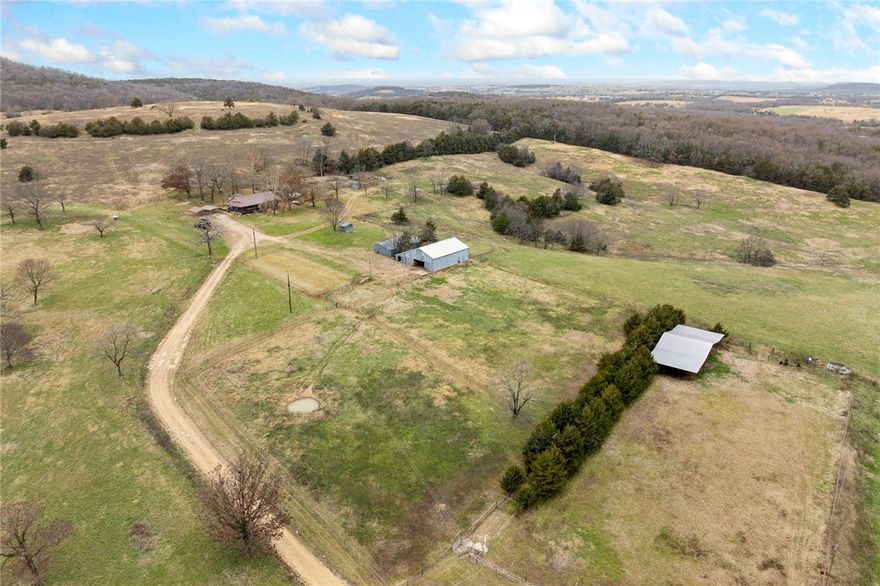 Have you been looking for a Carroll County farm with acreage, privacy, and hunting opportunity? Welcome to your new farm. This 172.59± acre property is located less than 10 minutes from downtown Berryville, Arkansas, offering a rare balance of seclusion and convenience.
The land is primarily open with gently rolling pasture, complemented by mature timber, and is fully fenced-ideal for running cattle. Five ponds provide water for livestock and attract abundant wildlife. The property’s rolling topography offers scenic views across the Ozark hills.
Improvements include a 1,856 sq ft home with 3 bedrooms, 2 bathrooms, and a gas fireplace, along with a barn, multiple sheds, and additional outbuildings. Three older poultry houses are also on site and could be repurposed for storage with some work.
Deer and turkey are prevalent, making this an excellent hunting and recreational property. If you’re looking for a farm you can truly make your own, don’t miss this one.