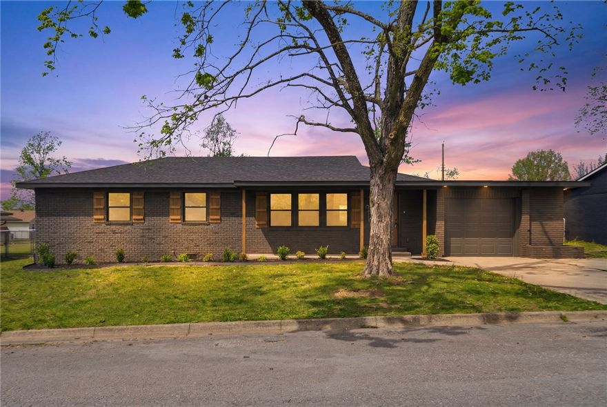 Completely turnkey and move-in ready, this beautifully remodeled Rogers home checks every box. Ideally located just minutes from downtown Rogers, dining, shopping, and everyday conveniences, this one sits right in the heart of it all. Major systems are all new — roof, HVAC, water heater, and windows — so buyers can move in with total confidence. Inside, you'll find luxury vinyl plank flooring throughout, fresh paint, retextured walls, new doors, new light and plumbing fixtures, and a stylish accent wall in the living room. The kitchen shines with new cabinetry, quartz countertops, tiled backsplash, and stainless steel appliances. Two living areas offer flexible use, one featuring a wood-burning fireplace. The primary bedroom includes a partial walk-in closet with built-ins and an en-suite with tiled shower, quartz countertops, and new vanity. Guest bath is equally updated. Laundry room with new cabinetry, tile floor, and W/D hookups. New deck, fresh landscaping, and a one-car garage complete this stunning package.