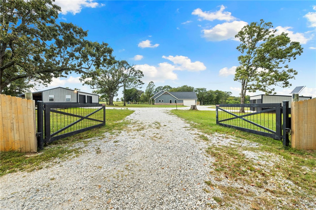 Escape to your own 30-Acre sanctuary blending sustainable living with modern comfort. This 95% self-sufficient newer built homestead (2020) features 15 Acres of hay fields, a stocked pond, mature trees, and a maintained yard. With raised beds in a 30x20 greenhouse (2024), A new 15 gpm well (10/24), chicken coop with water, woodshed, 20x40 shop with 220, 20x30 storage garage, and generator-ready wiring; it provides true independence. The 4BR home (plus bonus room) offers granite counters, modern appliances, and a wood-burning stove (2024) with custom hearth. Gas heat, mini split upstairs, attic storage, and 2-car garage add convenience. Enjoy the peaceful porches with breathtaking views and a gated drive for privacy. Perfect for farming, prepping, or simply escaping the city, this property has everything you need to thrive off-grid and in comfort.
Too many features to mention them all...this is a MUST SEE!