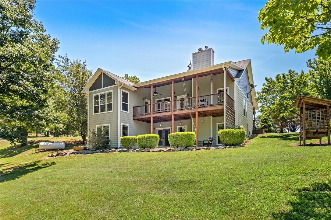 18 acres, a dreamy Ozark oasis with a custom built, steel beam, poured wall foundation craftsman style awaits your visit. Only a mile from Indian Creek Park, Beaver Lake boat ramp and the Bertram, White River boat ramp. Location is a short 10 miles to Roaring River, MO, 22 miles to Downtown Rogers, 9 miles to Eureka Springs.
The main house offers a practical floor plan with 3 bedrooms, 3 baths, 2 fire places. The living room, office space, master bedroom, formal dining, eat in kitchen and laundry room complete the main level. From the great front porch and several patios on both both levels, one can enjoy lots of out door living areas. The finished walkout basement with kitchenette, bonus living and gym/storage room are also part of this comfortable establishment.
Be sure to check out the three outbuildings, including 15X23 foot detached party pavilion, seven person hot tub, a separate 30X24 foot barn/shop building and additional 18X30 foot boathouse/barn.