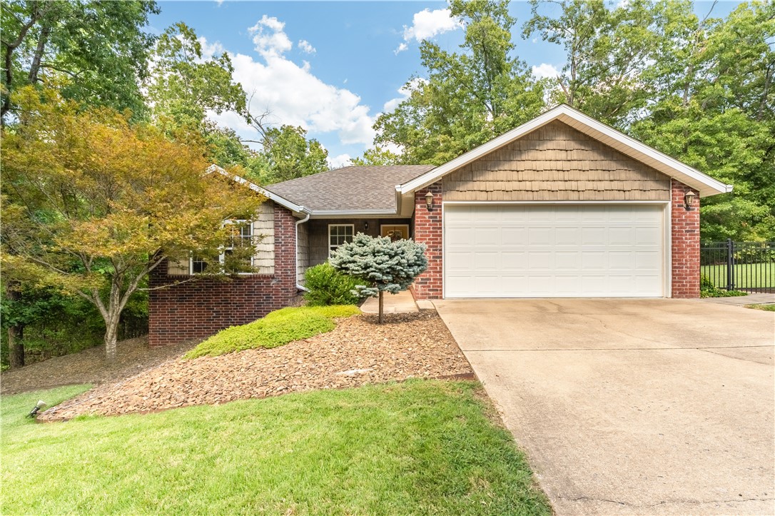 This charming two-bedroom, well maintained home, on 2 lots, totaling a little over half an acre is a must-see. Bella Vista POA land provides extra privacy, creating your own personal oasis. With a flex space, it can become a 3-bedroom home or serve as a 2-bedroom with an office or den. Inside, the split floor plan features high ceilings, ceramic tile flooring, a cozy gas log fireplace, a dining area, and granite countertops. The master en suite boasts a walk-in handicap-accessible shower. You'll love the composite deck that spans the entire length of the home, complete with a pergola and ample space for a grill and seating areas to take in the tree-lined property and the large, flat, fenced yard. Additional highlights include a newer 10x16 shed, newer HVAC, a level driveway, handicap-accessible layout with wide doorways, remote-controlled bedroom shades, an irrigation system and even a heated and cooled garage. Less than a mile to bike trails. See it today.