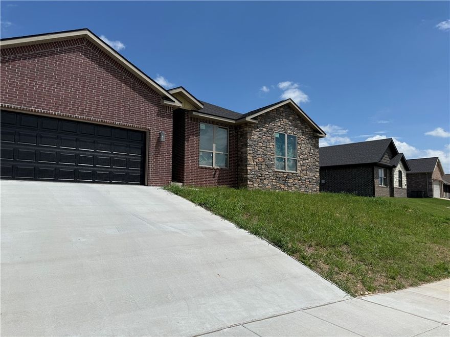 Welcome to your wonderful and very comfortable new home in Cave Springs, the jewel of Northwest Arkansas. This amazing brick and rock home has an awesome open floor plan with 4 bedrooms, two full baths and walk-in closets in 3 bedrooms. Many custom features include ceiling fans, granite counters, tall ceilings, lighted mirrors, a utility sink, and oversized windows that let you see the sky, extra storage, security lights, LED lighting. The gourmet kitchen has cabinets to the ceiling, a spice rack, soft close hinges, 2 pantries, large drawers, a tip tray, pull out trash cans and a wine rack. Level fenced backyard with huge covered patio. Don't miss the opportunity to live in the center of Northwest Arkansas in a fantastic family friendly neighborhood. Easy access to i-49, Wal-Mart Home Office J B Hunt, Promenade Mall, restaurants and schools. XNA National Airport is only a few minutes away.