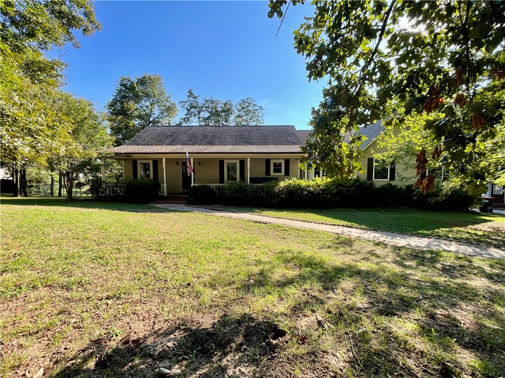 Welcome to this spacious home on a large .64-acre lot with a huge fenced backyard! Enjoy the oversized 2-car attached garage with soaring ceilings and a detached 2-car workshop/garageāperfect for projects or storage. A full-length covered front porch welcomes you, while the back deck is accessible from both the living room and the master suite via new patio doors. Inside, the heart of the home is the oversized living room with hardwood floors and a cozy wood-burning stove. The split floor plan offers privacy with two generous guest bedrooms on one side, and a serene master retreat on the other. Master features double vanities and dual walk-in closets. Youāll love the bright white kitchen with an electric wall oven, separate cooktop, and a sunny breakfast nook. A formal dining room with hardwood floors adds charm and function. Space, character, and functionalityāall in one beautiful Hilltop home! $10,000 concession to Buyer for new paint and flooring. Just a few updates and this home is a show stopper!!