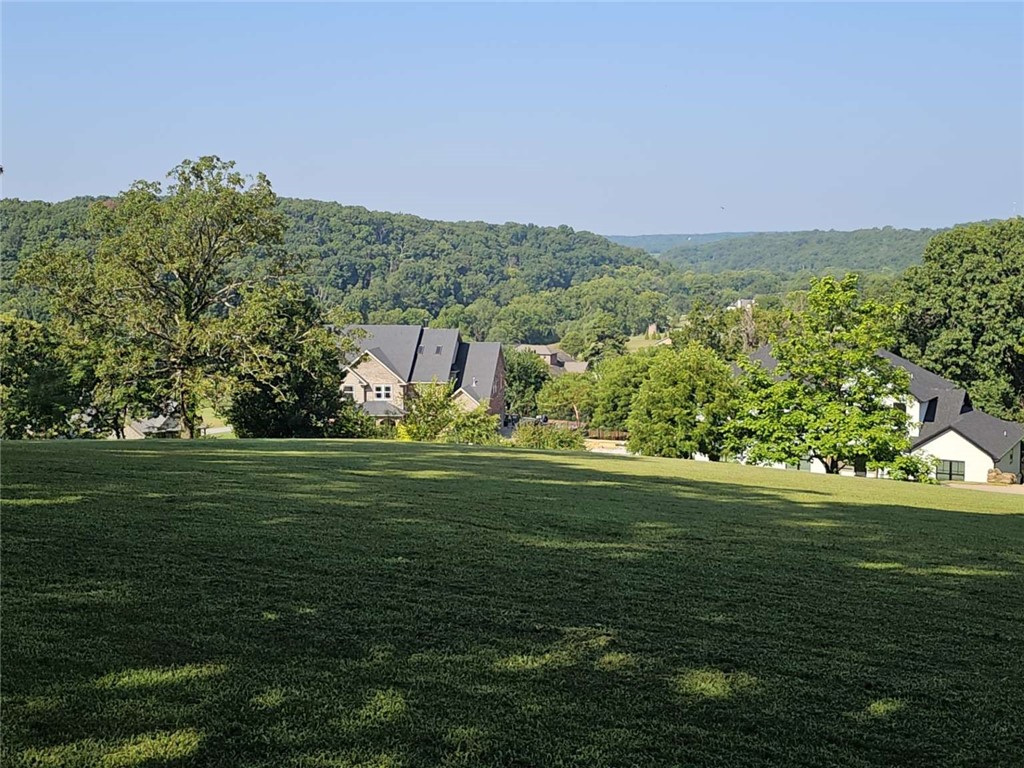 Beautiful Bentonville hilltop lot with an expansive view of Spanker Creek Valley in the highly sought Eau Claire subdivision. This 1.27 acre lot is mostly cleared and ready for the home of your dreams. This truly is one of the best views in Bentonville. You have to see it to appreciate it!